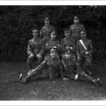 Corporal Thomas Edward Rendle, VC. Possibly 1915. Picture of Thomas Rendle (born Bedminster, Bristol on the 14th December 1884 and who was awarded the Victoria Cross) with some of his battalion colleagues, including an officer. He sits in the middle row, second from the left. At the time of his award he was a bandsman in the 1st Battalion, Duke of Cornwall's Light Infantry and was acting as a stretcher bearer. He was 29 years old. His citation reads "For his conspicuous bravery on 20 November 1914 near Wulvergem, when he attended to the wounded under very heavy shell fire and rifle fire, and rescued men from the trenches in which they had been buried by the blowing in of the parapets by the fire of the enemy's heavy howitzers". He was the only stretcher bearer to receive a Victoria Cross in World War 1. His medal is held at the DCLI museum in Bodmin. He was awarded the medal by King George V on 12 July 1915. He died in 1946 in Cape Town South Africa. (During the war a soldier called Thomas Randle impersonated Rendle and attended talks and meetings etc. until he was eventually caught!) Photographer: Arthur William Jordan.