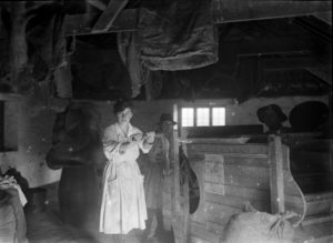 Members of the Women's Land Army pictured in a shed working a hand-operated chaff-cutter at Tregavethan Farm. Photographer: A W Jordan. © From the collection of the RIC (TRURI-1972-2-241).